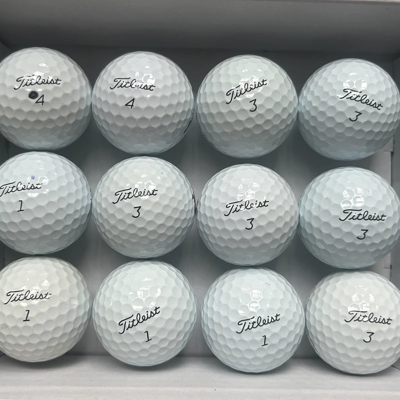 A dozen Grade A+ Titleist golf balls, bright and clean